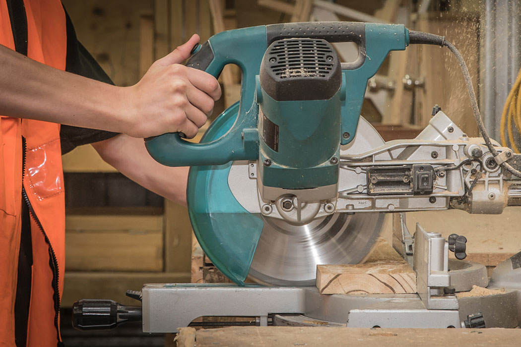 Trainee using a circular saw in the Ag Challenge carpentry workshop